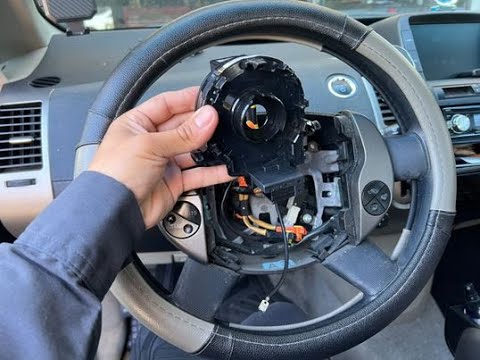 Vehicle steering-wheel airbag components being inspected
